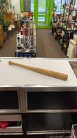 Full view of Hillerich & Bradsby wooden baseball bat on counter