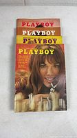 Front view of four stacked Playboy magazines