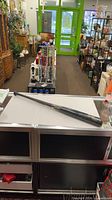 Full view of black Rawlings Adirondack baseball bat on counter