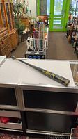 Full view of black Worth Tennessee Thumper 500T bat on counter