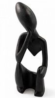 Full view of abstract black figurative sculpture in kneeling pose