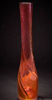 Front view of tall twisted art glass vase showing color gradient