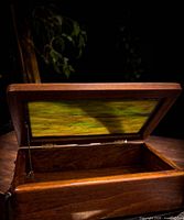 Box open showing interior wood and stay chain