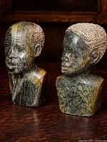 Front three-quarter view of both stone busts