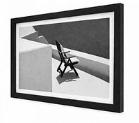 Oblique view of framed black-and-white architectural photograph showing frame depth and matting