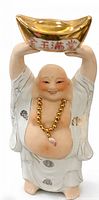 Front view of porcelain Laughing Buddha holding gold ingot, showing gold accents, necklace and robe details