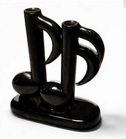 Front view of glossy black ceramic double candle holder shaped as musical notes