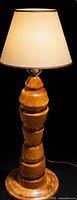 Full view of lamp showing wood base, shade, cord
