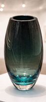 Front view of smokey teal art glass vase showing color gradient and clear base