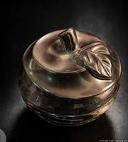 Front angled view of chrome apple showing full form and reflective finish