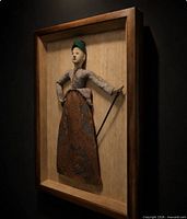 Oblique view of framed puppet artwork showing depth of shadow box