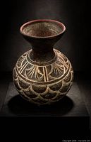 Front view of hand-carved Moroccan earthenware vase showing flared neck and incised geometric motifs