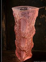 Front view of pink textured glass vase showing square rim and relief details