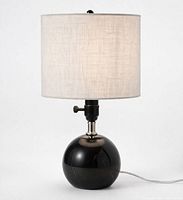 front view of black marble globe table lamp with staging shade attached
