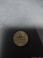 Reverse side showing ONE CENT 1910 within vine border