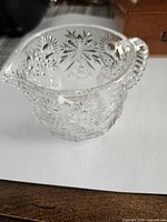 Side view showing raised starburst pattern and beaded handle