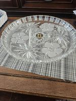 Top view showing etched floral and starburst pattern, brass center screw