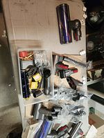 Overview of table with multiple Dyson V-series attachments and accessories