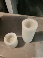 Large and small ivory flameless candles unwrapped view
