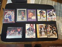 All nine cards laid out on black mat showing fronts