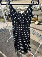 Full front view of chiffon polka dot slip dress on hanger