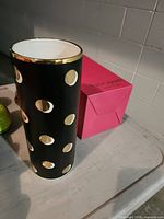 Vase standing beside original pink box