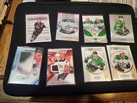 All eight hockey cards laid out on black background