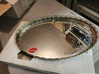 Gold-plated oval mirror tray with spotting