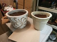 Two planters on table showing sizes and designs