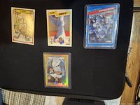 All four sleeved baseball cards laid out