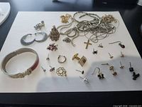Full view of all mixed jewelry pieces spread on white sheet