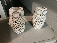 Two cream ceramic owl lanterns front view