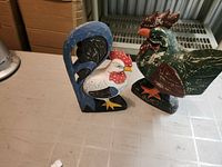Both carved wood roosters front view