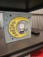 Front view showing Snoopy, Woodstock, yellow moon graphic and text