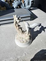 Front view of porcelain hummingbird figurine on white base