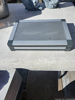 Speaker closed showing silver grille and case