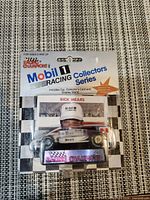 Front of sealed package showing car, card, display stand