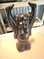 Front view of resin Laughing Buddha statue, arms raised