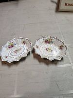 Top view of both scalloped floral trinket dishes
