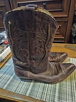 Left side profile of both boots showing stitching and leather condition