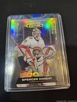 Front of Spencer Knight Stature rookie card in plastic holder showing autograph and serial #007/199