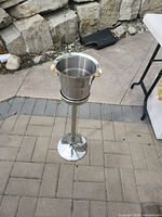 Full view of stainless cooler bucket on pedestal stand