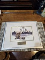 Front view of framed print under glass on table