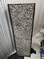 Full front view of tall rattan floor lamp