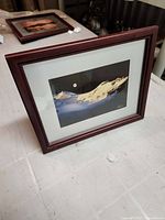 Front view of framed photograph showing image, mat, and mahogany frame