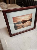 Framed photograph angled view showing wood frame, double mat, image