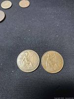 Front view of both coins showing Britannia reverse designs and dates