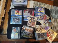 Overall lot of 18 Upper Deck hockey cards on black mat with Series Two tin visible