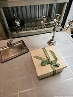 Group view of candelabra, rabbit tray and ribboned wooden box