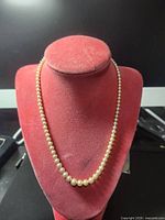 Full view of pearl necklace displayed on bust